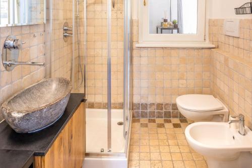 a bathroom with a sink and a toilet and a shower at Stella di Castion in Costermano