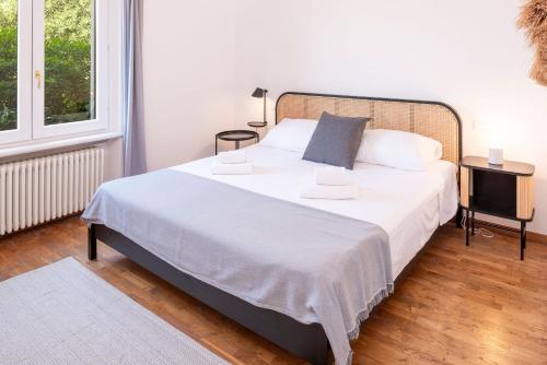 a bedroom with a bed with white sheets and a window at Stella di Castion in Costermano