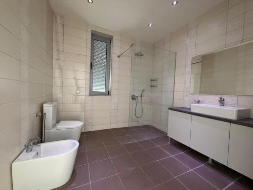 a bathroom with a toilet and a tub and a sink at Villa Max in Krimovice