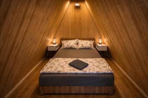 a bedroom with a bed with two night stands at Villa Kristal Slatina- Private Pool & Jacuzzi BBQ in Slatina Varoš