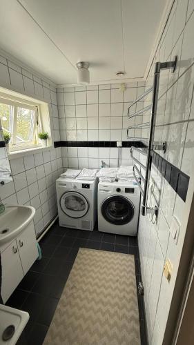 a laundry room with a washer and dryer in it at Ribe Villa in Stockholm
