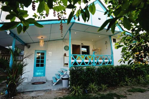 a house with a blue and white front porch at Dream Villa Beachside Sunset in Ban Bang Po