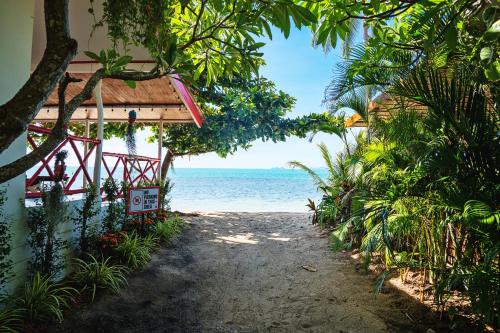 a beach house with a view of the ocean at Dream Villa Beachside Sunset in Ban Bang Po
