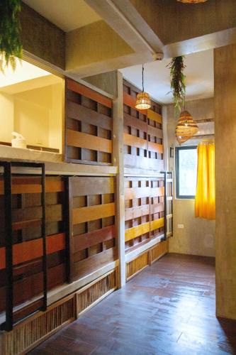 a large room with wooden doors in a room at Happiness Hostel El Nido in El Nido