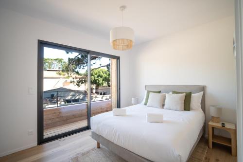 a bedroom with a white bed and a large window at Strada Rossa in Lecci