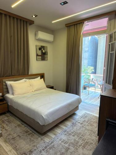 a bedroom with a bed and a sliding glass door at Excellent Location cairo in Cairo
