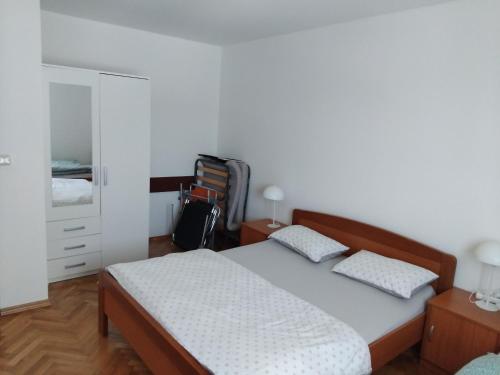 a bedroom with a bed and a dresser at Apartman Baška Voda in Baška Voda