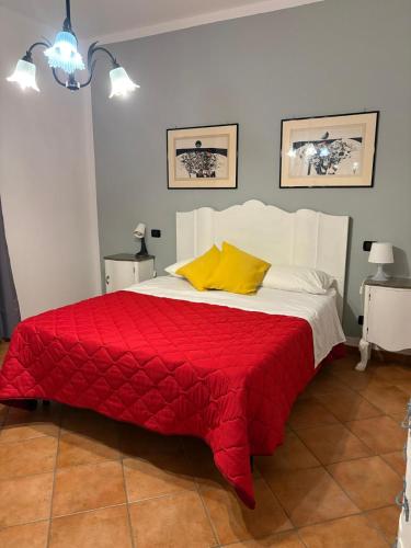 a bedroom with a red and white bed with yellow pillows at Villa Piruzzu CV Torre Mulinazzo app P in Cinisi