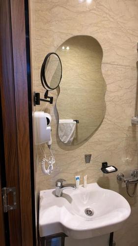 a bathroom with a sink and a mirror at Excellent Location cairo in Cairo