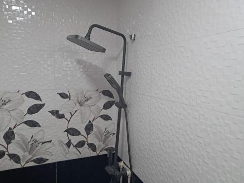 a shower head in a bathroom with a wall at Hotel kazbegi1 in Ach'khoti