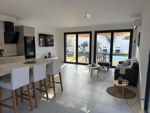 a kitchen and living room with a table and chairs at Villa ROC in Bandol