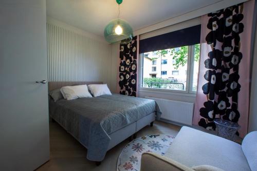 a bedroom with a bed and a window at Opera Magic Castle View, Air-Con, Free wifi in Savonlinna