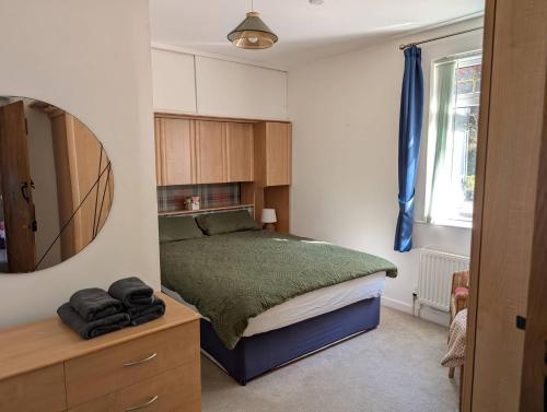 a small bedroom with a bed and a mirror at Callart View in Ballachulish