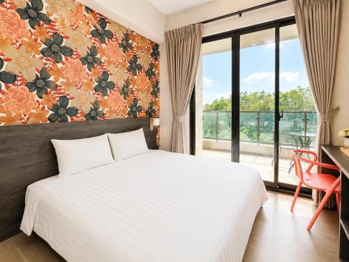 a bedroom with a white bed and a large window at Mo in Houli