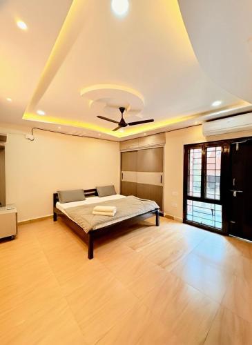 a bedroom with a bed and a ceiling fan at Serenity Villa in Rushikonda