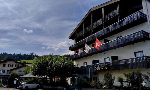 a hotel with a flag on the side of it at Hotel-Restaurant Bellevue in Flims