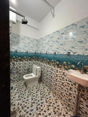 a bathroom with a toilet and a sink at Hotel 5G in Bhopal