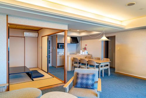 a living room with a dining room and a kitchen at Seagaia Forest Condominiums in Miyazaki