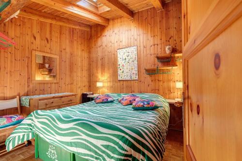 a bedroom with a bed in a wooden room at La Tana con l'Ermellino in Morgex