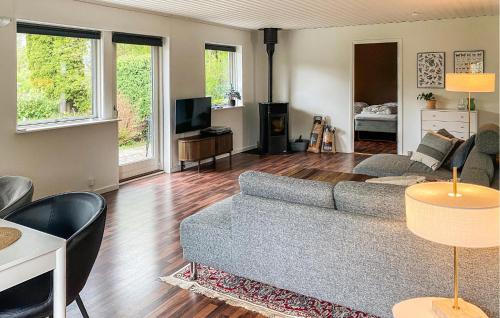a living room with a couch and a tv at Beautiful Home In Holbæk With Wifi in Holbæk