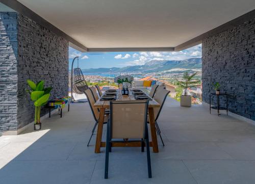 a table and chairs on a balcony with a view at Panorama Coastal Haven in Split