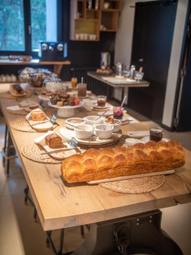 a long table with a bunch of food on it at Grand Hôtel & Spa NUXE Serre Chevalier in Saint-Chaffrey