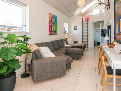 a living room with a couch and a table at 4 star holiday home in Børkop in Børkop