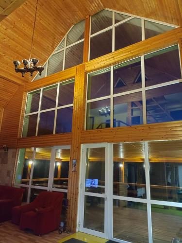 a living room with a large glass door at Cabana 7 izvoare in Remeţi