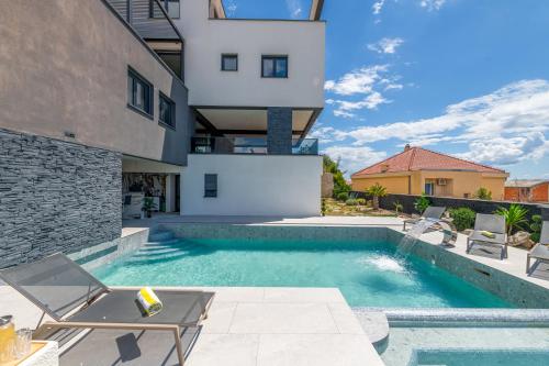 a swimming pool in front of a building at Panorama Coastal Haven in Split