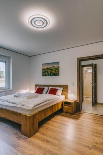 a bedroom with a large bed in a room at Malomfészek Apartman in Tapolca