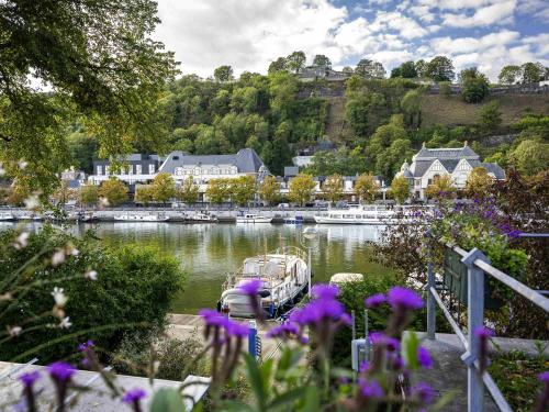 a boat is docked on the water in a lake at Mercure Namur Hotel in Namur