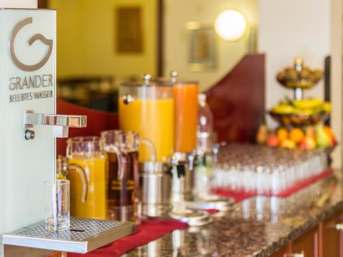 a counter with a bunch of orange juice at Austria Classic Hotel Wien in Vienna