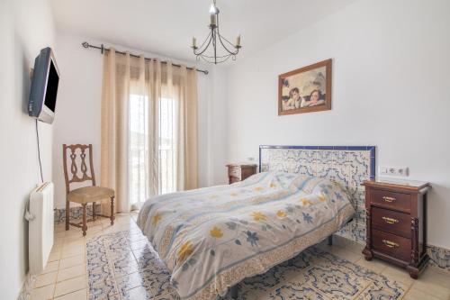 a bedroom with a bed and a dresser and a tv at El Corralon de Severo in Hinojales
