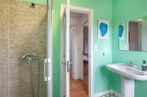 a bathroom with a sink and a shower at El Corralon de Severo in Hinojales