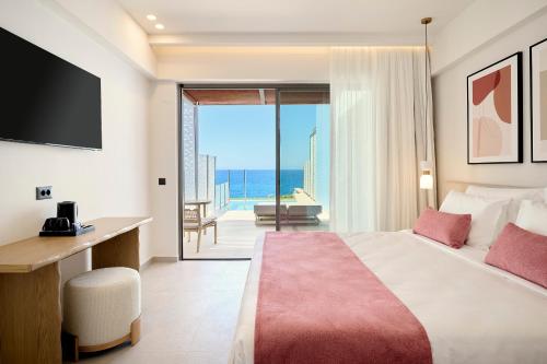 a hotel room with a bed and a view of the ocean at Iberostar Waves Creta Panorama & Mare in Panormos Rethymno