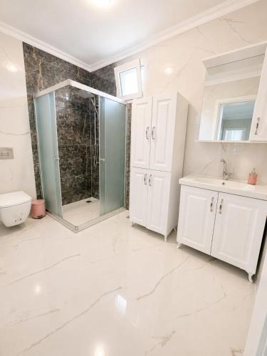 a bathroom with a shower and a sink and a toilet at Apart Portakal Çiçeği in Kaş