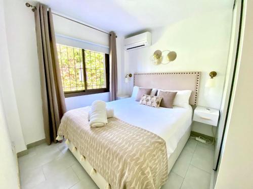 a bedroom with a white bed and a window at Wave & Garden Riviera - EaW Homes in Mijas Costa
