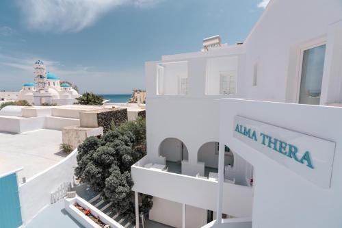 a view of a building with the ocean in the background at ALMA THERA Boutique Hotel in Perissa