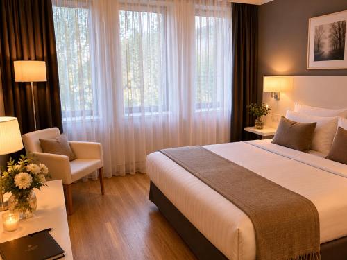 a hotel room with a large bed and a chair at guestified GRAND AIRPORT Hotel Düsseldorf Ratingen in Ratingen