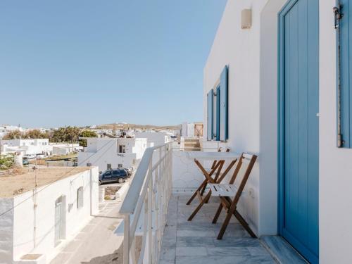 a balcony with a table and a view of the city at Kamara House - 200m from Naoussa Port in Naousa