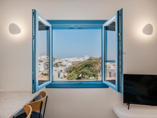 a room with a window with a view of the city at Kamara House - 200m from Naoussa Port in Naousa