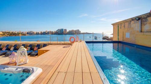 a swimming pool with a view of the water at Valletta Waterfront Villa with Pool and Jacuzzi in Valletta