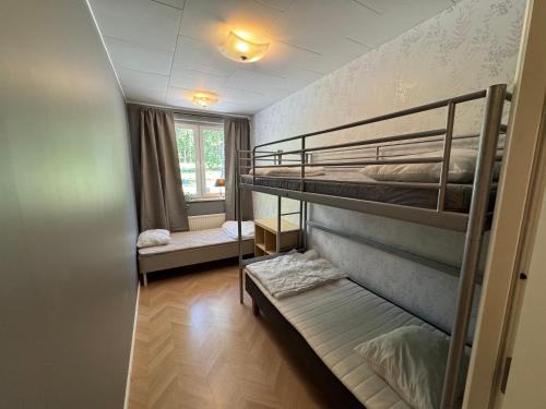 a room with two bunk beds and a window at Ekängens vandrarhem in Virserum