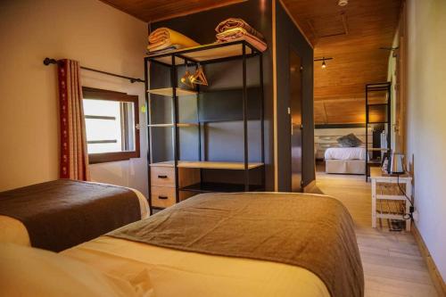 a bedroom with two beds in a room at Hotel Le Faranchin in Villar-dʼArène