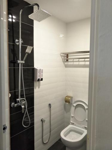 a bathroom with a toilet and a shower at Hotel Lavender Senawang in Seremban
