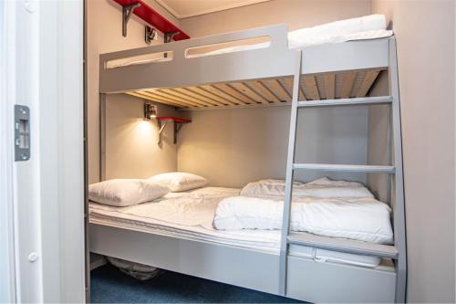 a bunk bed in a room with two beds at Hemavan Mountain Lodge Jofjället in Hemavan