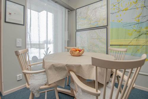 a dining room table with a bowl of fruit on it at Hemavan Mountain Lodge Jofjället in Hemavan