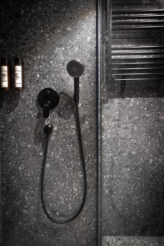 a shower stall with a hose on the floor at Savoy Hotel in Frankfurt