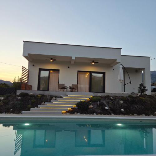 a house with a swimming pool in front of it at Villa Velaris Mostar in Mostar