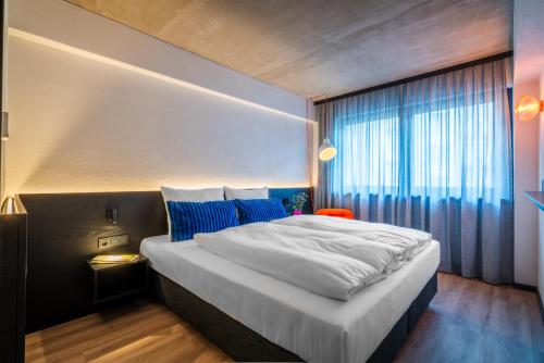a bedroom with a large bed and a window at Savoy Hotel in Frankfurt